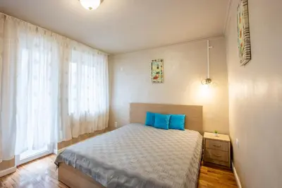 a bedroom with a bed with blue pillows at Blue Тerrace Apartment Top Center in Varna City