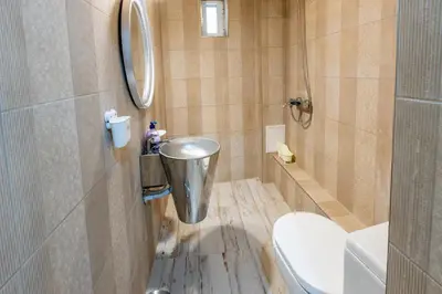 a small bathroom with a toilet and a sink at Blue Тerrace Apartment Top Center in Varna City