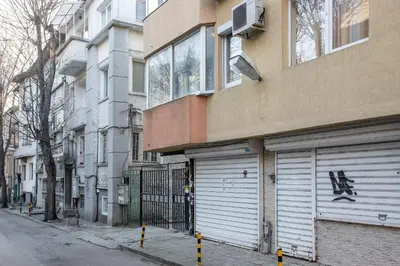 a building with a garage door on the side of a street at Blue Тerrace Apartment Top Center in Varna City