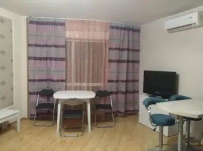 a room with a table and chairs and a tv at RUBIN-2 in Pomorie