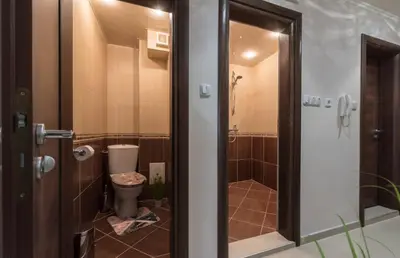 a small bathroom with a toilet and a shower at Apartment Aventurine in Varna City