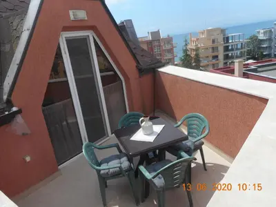a table and chairs on the balcony of a building at Studio Stoianovi in Nesebar