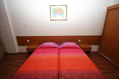 a bedroom with a bed with a red blanket at Tanya Hotel in Sunny Beach