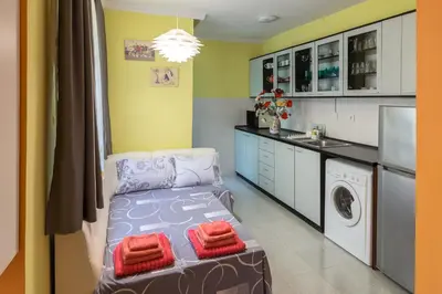 a small room with a washer and dryer in it at Kapriz - 2 beds aptmnt near the beach in Varna City