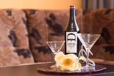 a bottle of wine and two glasses on a table at Kapriz - 2 beds aptmnt near the beach in Varna City