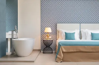 a bedroom with a bed and a bath tub next to a bed gmaxwell gmaxwell gmaxwell at Siena Premium Retreat in Lozenets