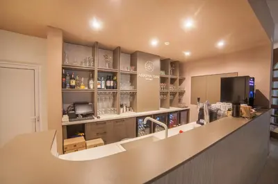 a bar with a counter and shelves with alcohol at Arapya Sun Resort in Arapya