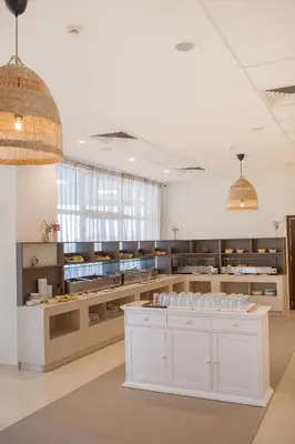a large kitchen with white cabinets and counters in a room at Arapya Sun Resort in Arapya