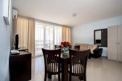 a room with a table and chairs and a living room at Arapya Sun Resort in Arapya