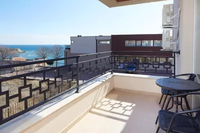 a balcony with a view of the ocean at Niko's Apartments Deluxe in Nesebar