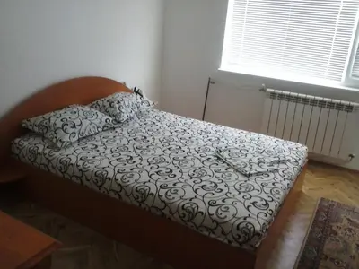 a small bed in a room with a window at Семеен хотел Стаси in Pomorie