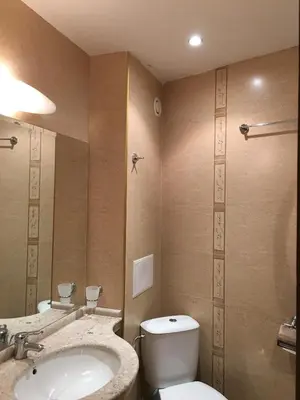a bathroom with a toilet and a sink at Hotel Sunny Bay Pomorie in Pomorie