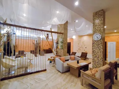 a large living room with a clock on the ceiling at Moonlight Hotel - All Inclusive in Sveti Vlas