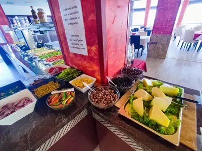 a buffet with different types of food on a counter at Moonlight Hotel - All Inclusive in Sveti Vlas