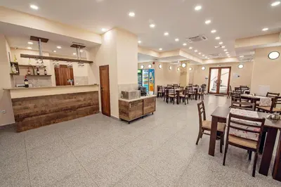 a restaurant with tables and chairs and a bar at Hotel Santa Maria in Obzor