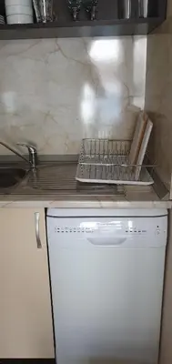 a kitchen with a stove and a white dishwasher at Apartament CACAO RESIDENCE in Sunny Beach