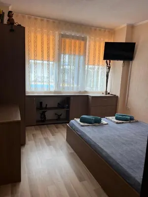 a bedroom with a bed with two pillows on it at Апартамент Морска Звезда in Nesebar