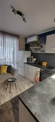 a kitchen with a couch and a table in a room at Апартамент Морска Звезда in Nesebar