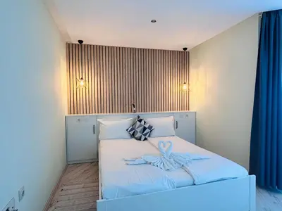 a bedroom with a white bed with a towel on it at PARADISO 'В' 311 Private Studio Nesebar in Nesebar