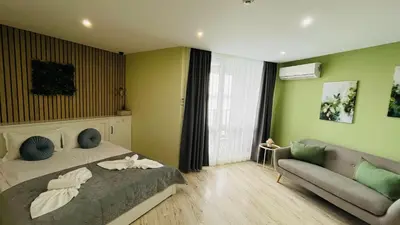 a bedroom with a bed and a couch at PARADISO 'В' 311 Private Studio Nesebar in Nesebar