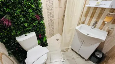 a bathroom with a white toilet and a sink at PARADISO 'В' 311 Private Studio Nesebar in Nesebar