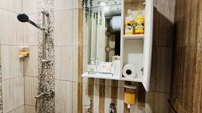 a bathroom with a shower with a sink and a mirror at PARADISO 'В' 311 Private Studio Nesebar in Nesebar