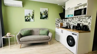 a living room with a couch and a washing machine at PARADISO 'В' 311 Private Studio Nesebar in Nesebar