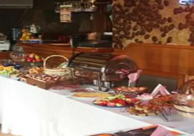 a counter top with a bunch of food on it at Kalypso Hotel in Primorsko