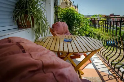 a wooden table and a chair on a patio at Kalypso Hotel in Primorsko