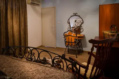 a bedroom with a bed and a table and a chair at Kalypso Hotel in Primorsko