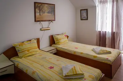 two beds sitting next to each other in a room at Kalypso Hotel in Primorsko