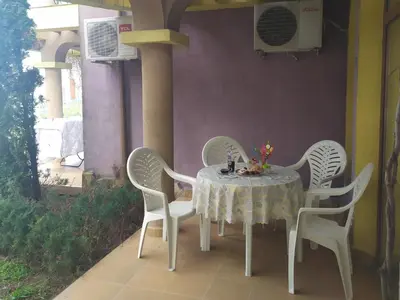 a table and four chairs sitting on a patio at Гардън Бийч - НЕДЯЛКОВИ in Sozopol