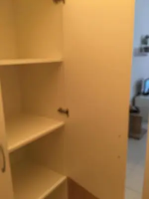 a cupboard with a door open in a room at Apart Hotel salt Lake in Pomorie