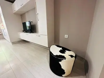 a black and white chair sitting in a living room at STUDIO KATRIN in Nesebar