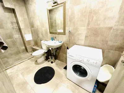 a bathroom with a washing machine and a sink at STUDIO KATRIN in Nesebar