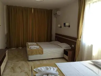 a hotel room with a bed and a window at Flower Street provides accommodations with free Wifi, air conditioning in Sunny Beach