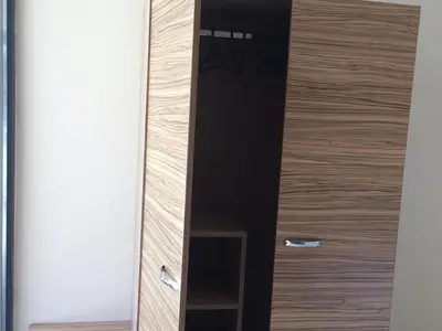 a wooden cabinet with a mirror in a room at Flower Street provides accommodations with free Wifi, air conditioning in Sunny Beach