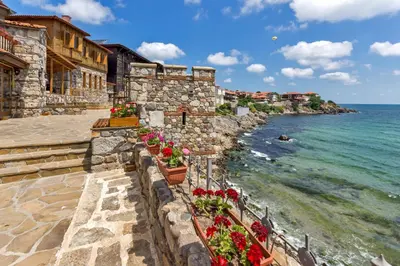 a stone wall with flowers on the beach at Flower Street provides accommodations with free Wifi, air conditioning in Sunny Beach