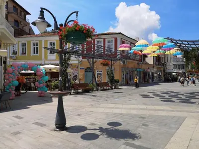 a city street with umbrellas in the middle of a town at Hotel Tm Deluxe located in Sunny Beach in Sunny Beach