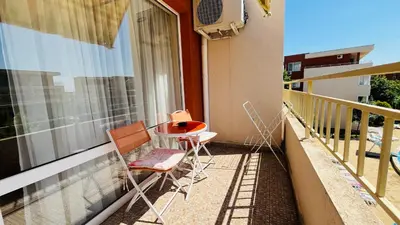 a balcony with two chairs and a table on it at FORT NOKS NESSEBAR B2-216 Studio SUNNY BEACH in Sunny Beach