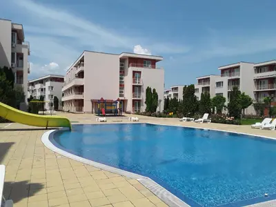 a swimming pool with a slide in front of some buildings at FORT NOKS NESSEBAR B2-216 Studio SUNNY BEACH in Sunny Beach