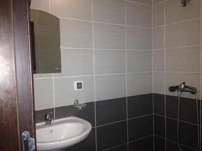 a bathroom with a sink and a mirror at Salt Lake ApartHotel in Pomorie