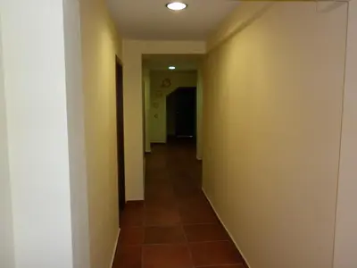 a hallway with yellow walls and a tile floor at Ivanova Cheshma Guest House in Varna City
