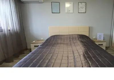 a large bed in a room with two night stands at K&K Stylish Elegance in Burgas City
