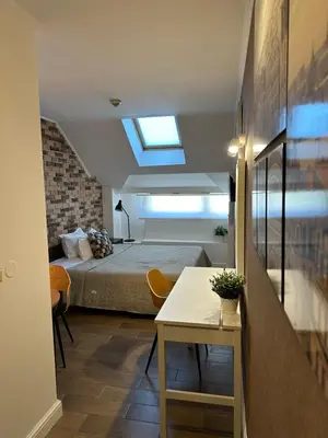 a bedroom with a bed and a table in a room at Hotel Art in Varna City