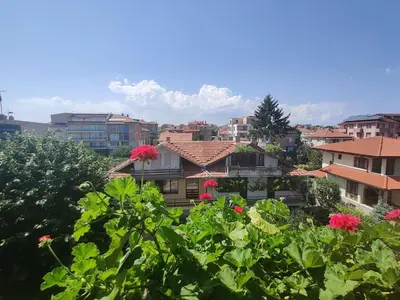 a view of a city with pink flowers and buildings at Art Villa Rozalia in Ravda