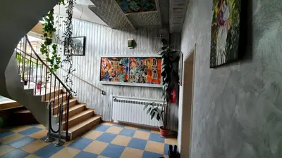 a hallway with a staircase and a tile floor at Art Villa Rozalia in Ravda