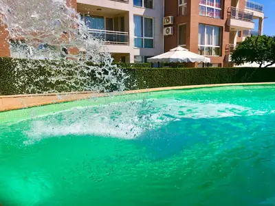 a swimming pool with a fountain in front of a building at Sea View NewApartment-Bulgaria-Chernomorets in Chernomorets