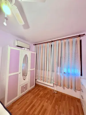a living room with a large window with curtains at Sun Palace apartments in Sveti Vlas