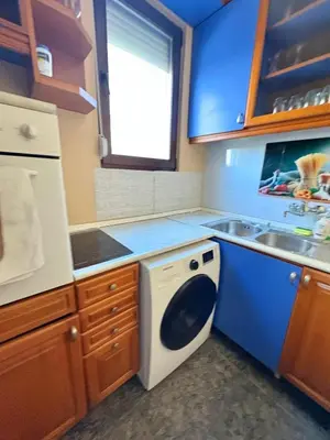 a small kitchen with a washing machine and a sink at Sun Palace apartments in Sveti Vlas